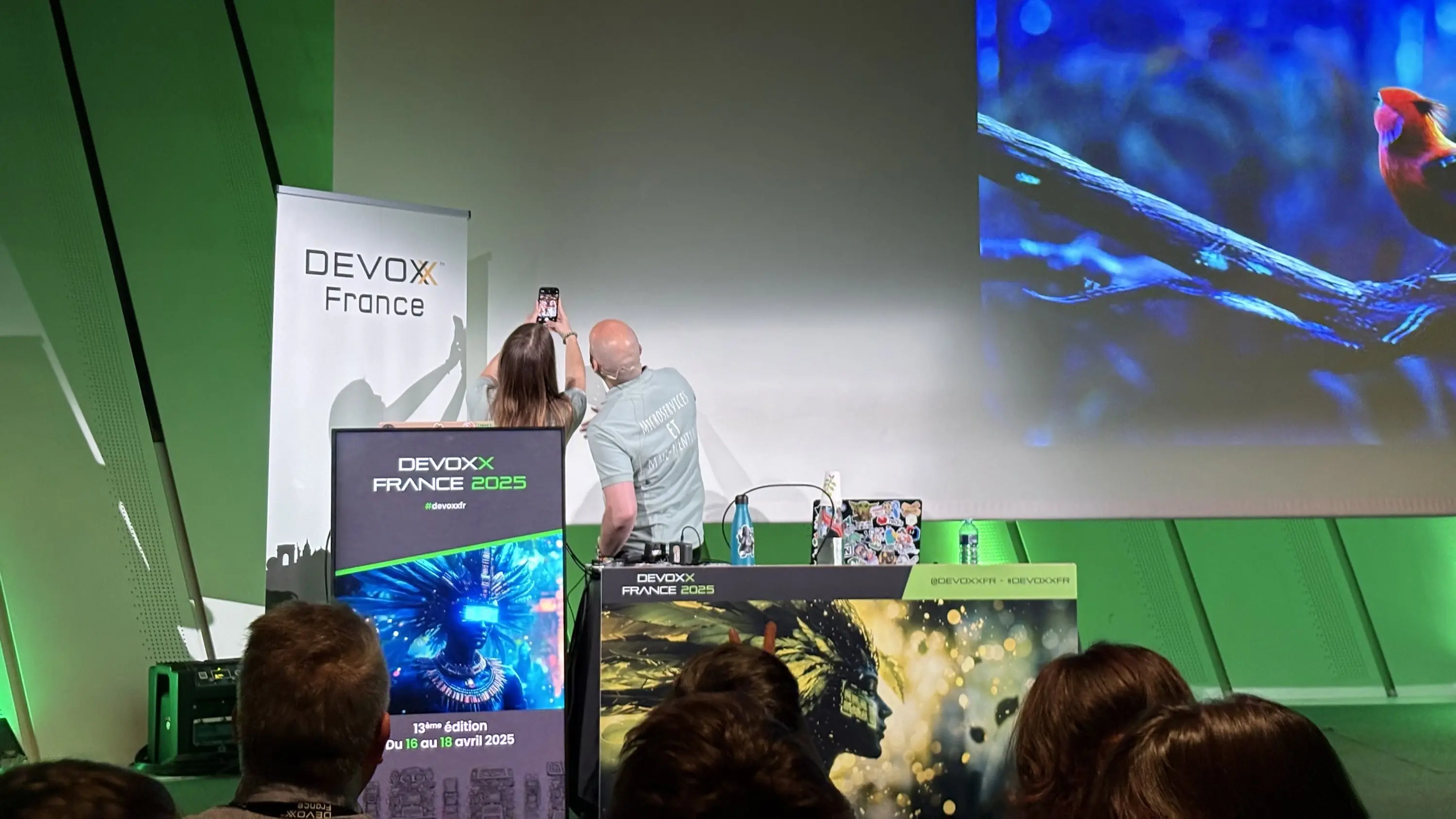 Photo of Loïc Ortola and Mathilde taking a selfie with the audience. (On LinkedIn, you can find the selfie with the audience.)