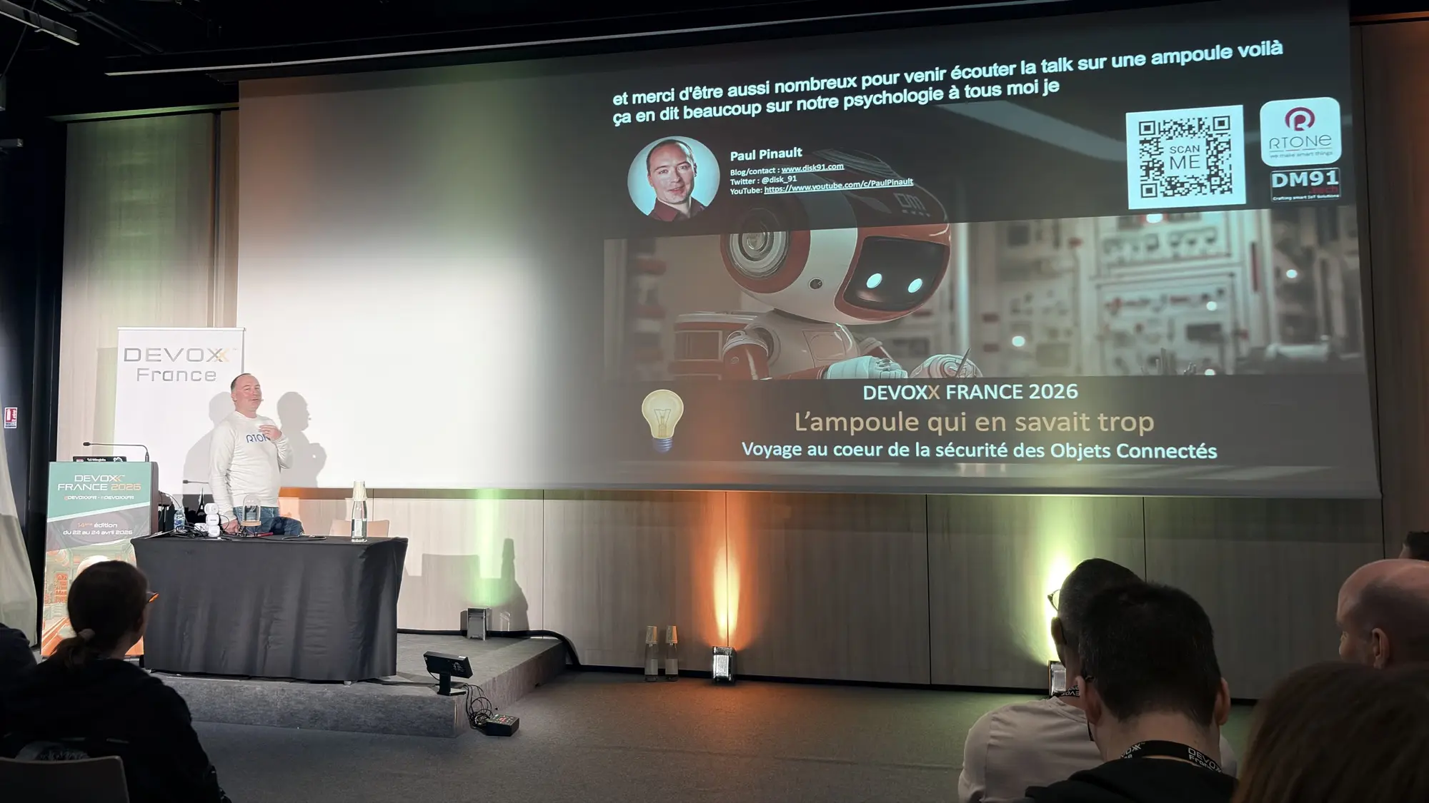 Paul on stage, during his talk about the security of connected objects